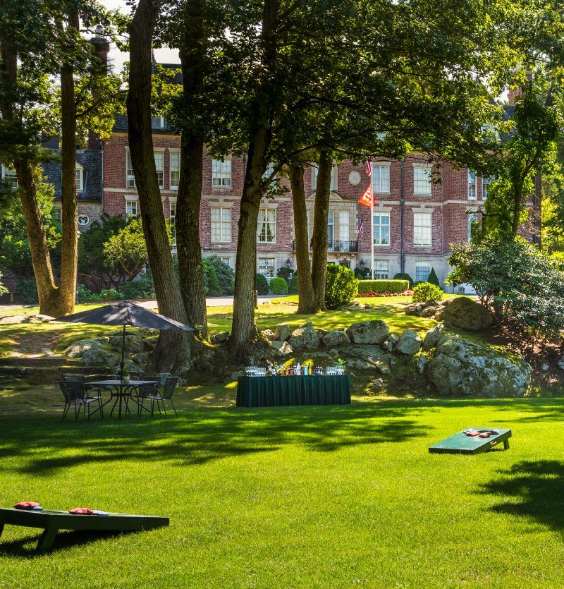 The estate grounds set for lawn games under the trees